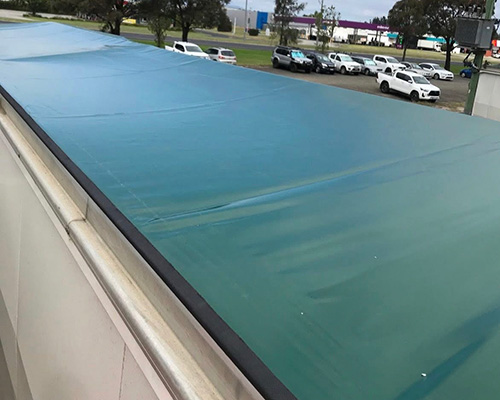 Roll over tarp system on a truck